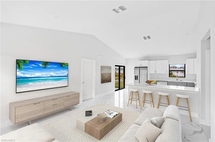 Living room featuring light marble finish flooring and lofted ceiling