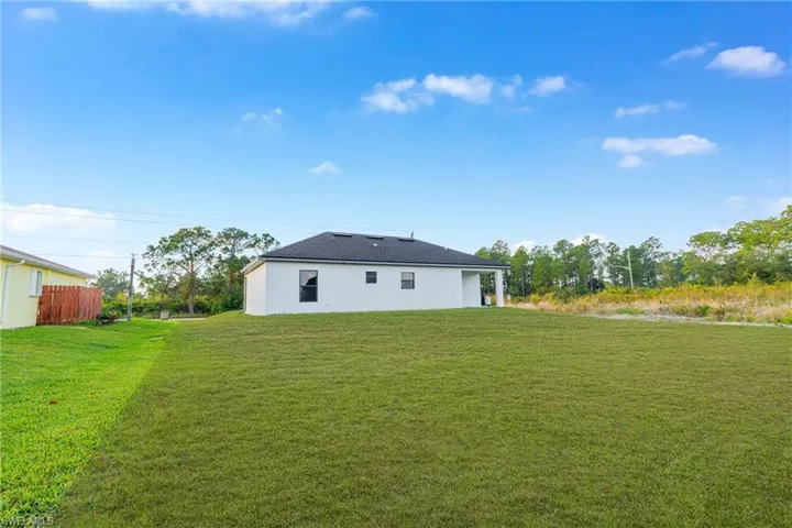 Rear view of property featuring a lawn