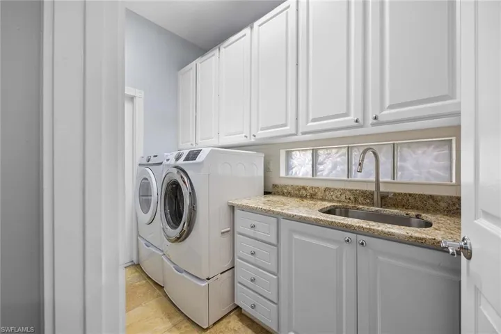 Laundry room with washing machine and clothes dryer and cabinet space