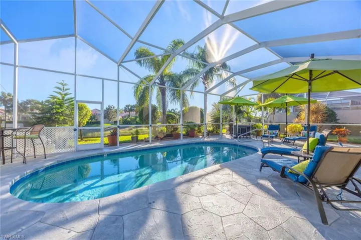 Outdoor pool featuring a lanai, a sunroom, and a patio area