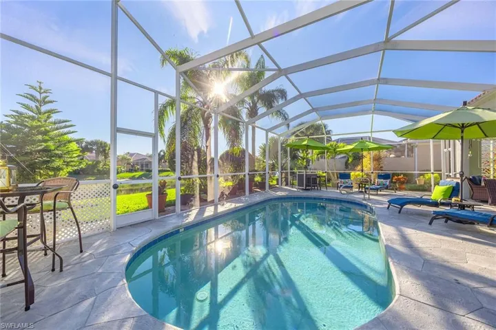 View of pool featuring a sunroom, a lanai, and a patio