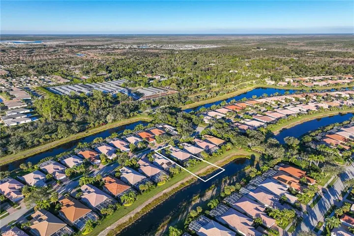 Aerial view of property's location featuring nearby suburban area and a nearby body of water