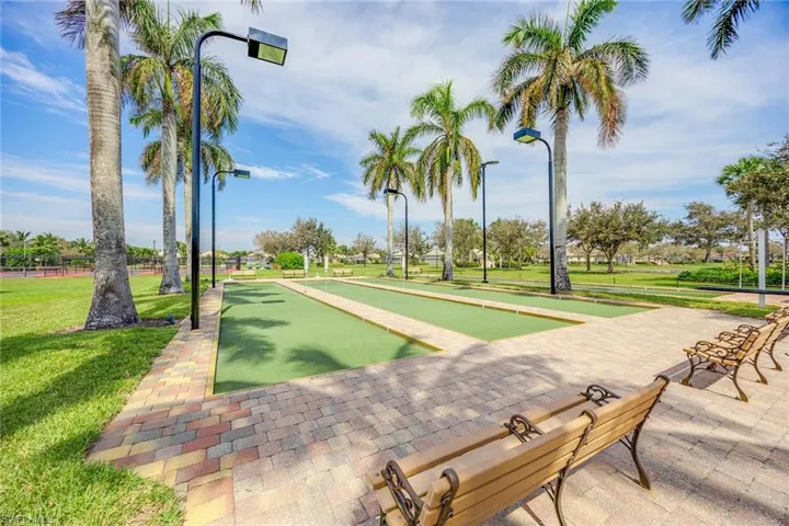 View of community featuring a game area and a lawn