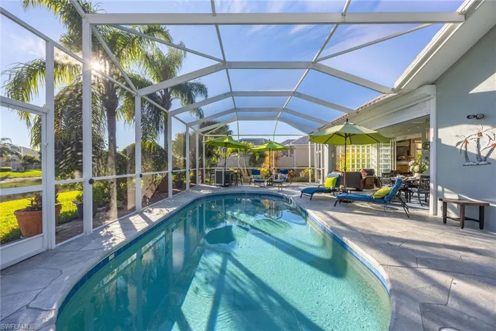Swimming pool featuring a sunroom, a patio, and a lanai