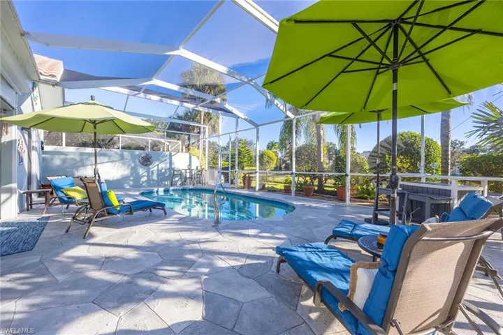Outdoor pool featuring a lanai, a patio area, and a sunroom