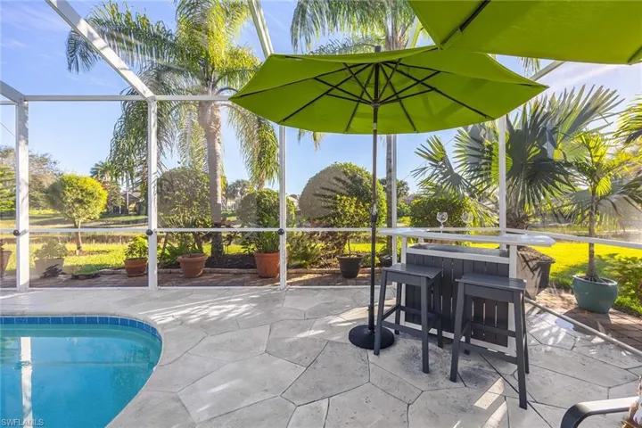 Swimming pool with glass enclosure