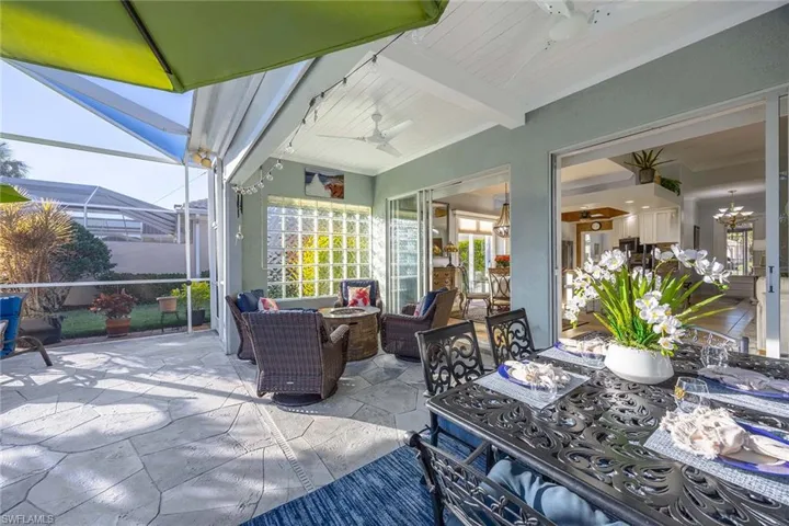 View of patio featuring a sunroom, a ceiling fan, a lanai, and an outdoor hangout area