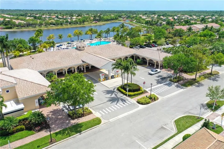 Aerial perspective of suburban area with a nearby body of water and a pool