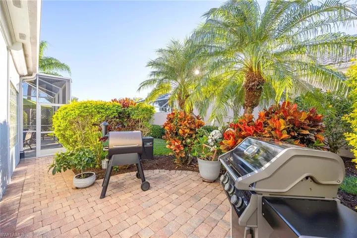 View of patio / terrace with grilling area, glass enclosure, and a sunroom