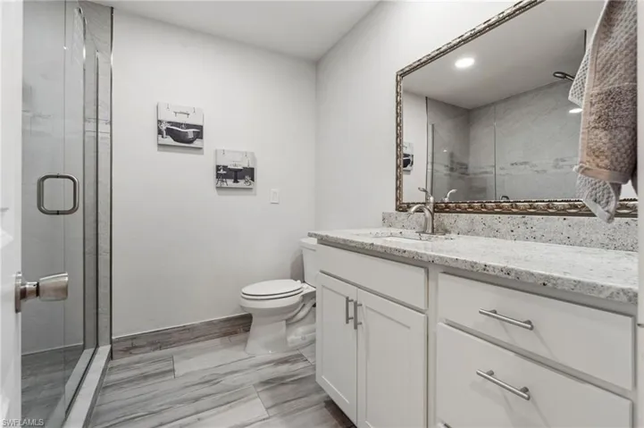 Full bathroom featuring vanity and a shower stall