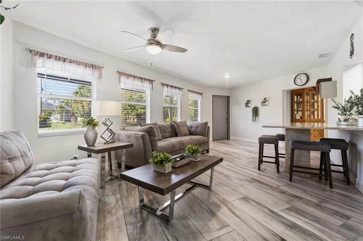 Living area featuring a ceiling fan and light wood finished floors