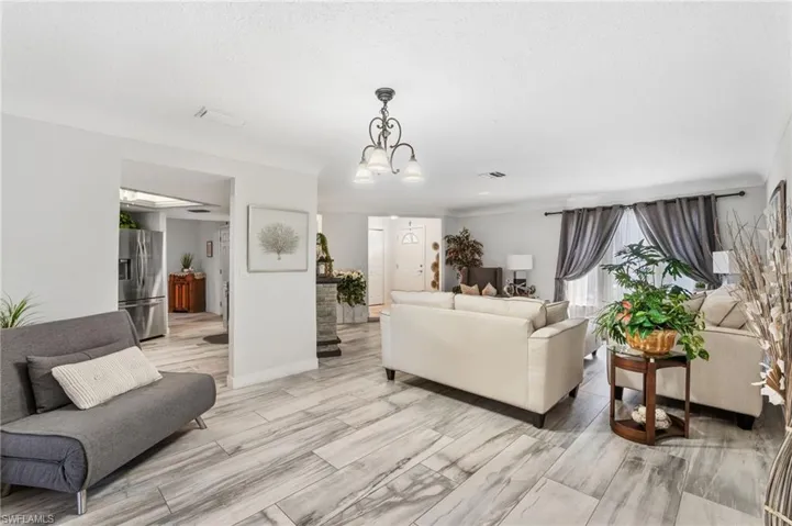 Living room with a chandelier and baseboards