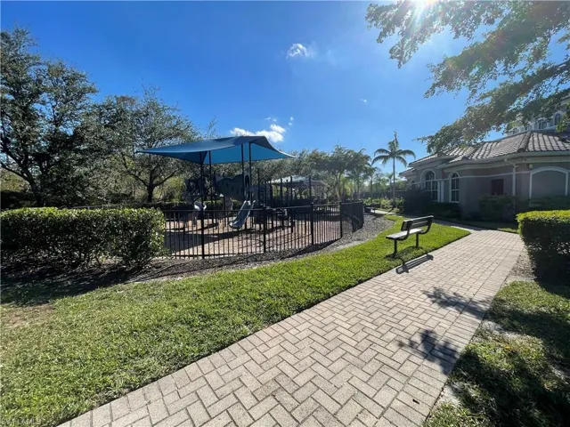 Surrounding community with a playground and a yard