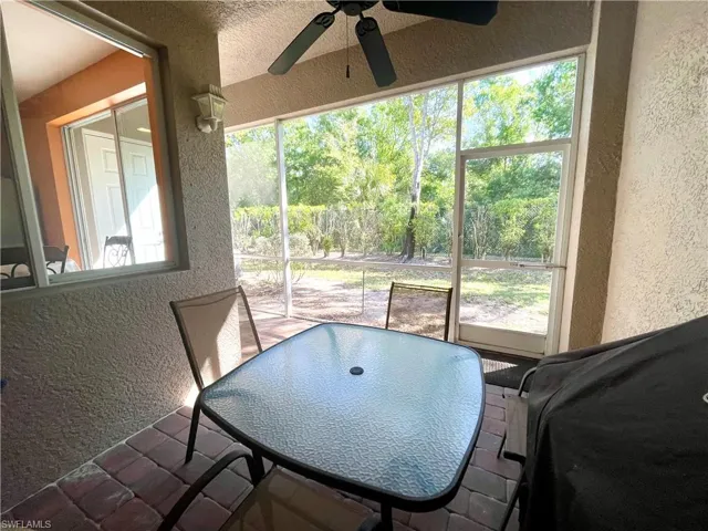 Sunroom / solarium featuring a healthy amount of sunlight and ceiling fan