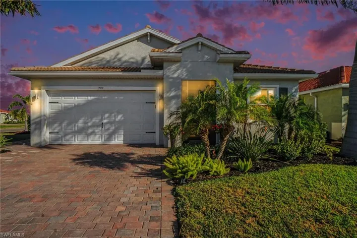 Ranch style home featuring a tile roof, an attached 2.5 car garage, patio driveway, and stucco exterior finish