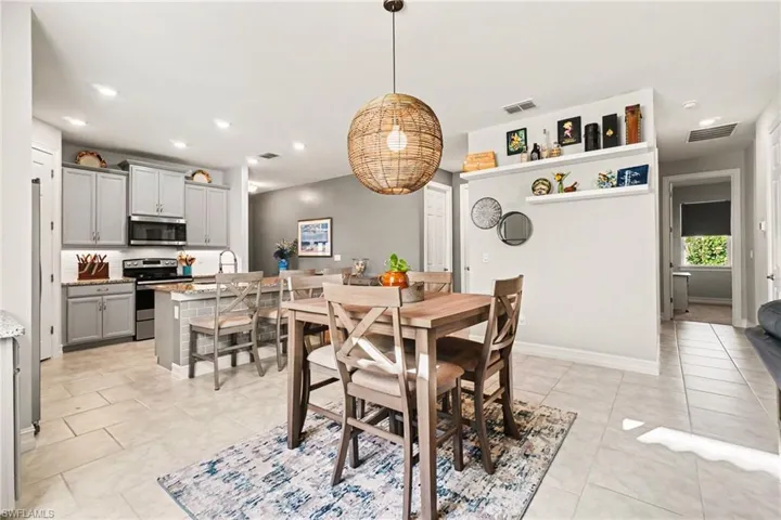 Dining space featuring recessed lighting and light tile patterned floors