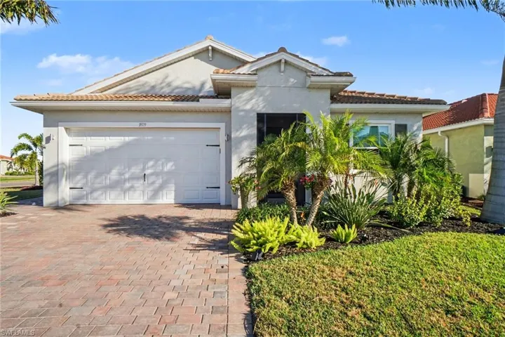 Ranch style home featuring a tile roof, decorative driveway, an attached 2.5 car garage, and stucco exterior finsh