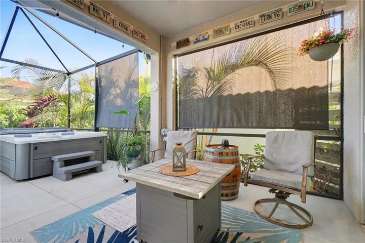 Sunroom featuring a hot tub and covered lanai