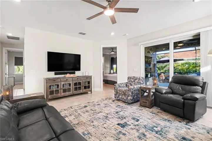 Living area featuring recessed lighting and light tile patterned flooring