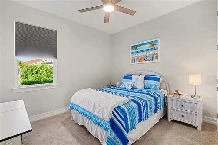 Bedroom featuring light colored carpet and a ceiling fan