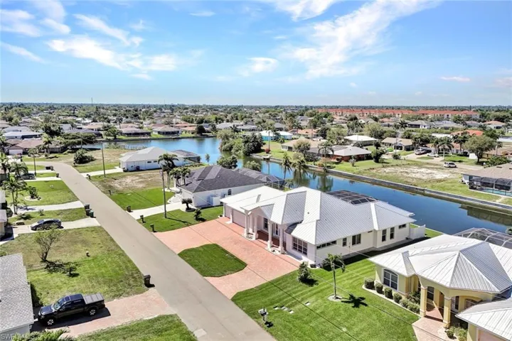Birds eye view of property with a residential view and a water view