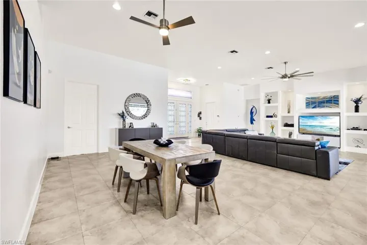 Dining room with built in features, ceiling fan, baseboards, and visible vents
