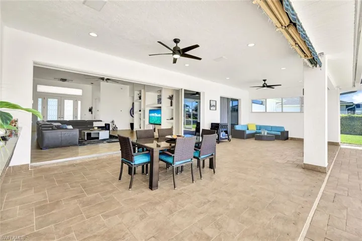 Dining room with plenty of natural light, french doors, a textured ceiling, and ceiling fan