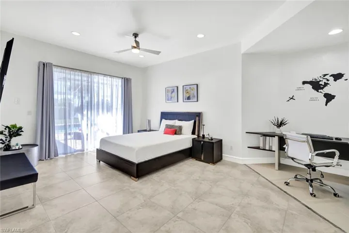 Tiled bedroom with a ceiling fan, access to exterior, recessed lighting, and baseboards