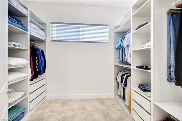 Walk in closet featuring light tile patterned floors