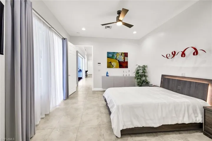 Bedroom featuring light tile patterned floors, visible vents, baseboards, recessed lighting, and ceiling fan