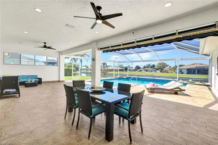 View of patio featuring outdoor dining space, an outdoor living space, a lanai, and ceiling fan