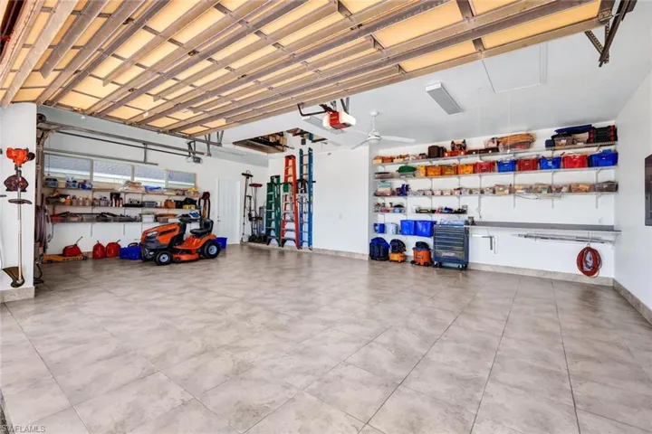 Garage with baseboards and a garage door opener