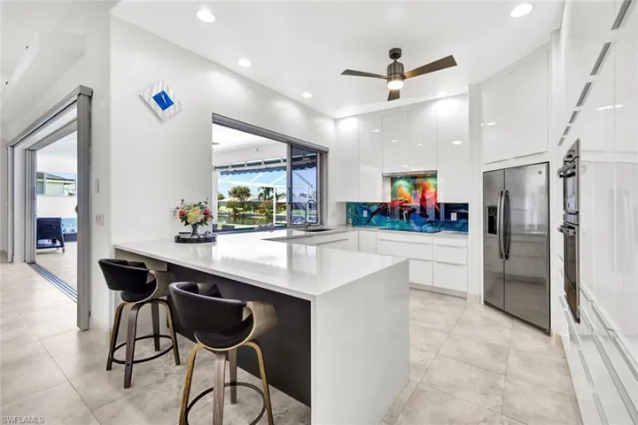 Kitchen with white cabinets, appliances with stainless steel finishes, modern cabinets, and a peninsula