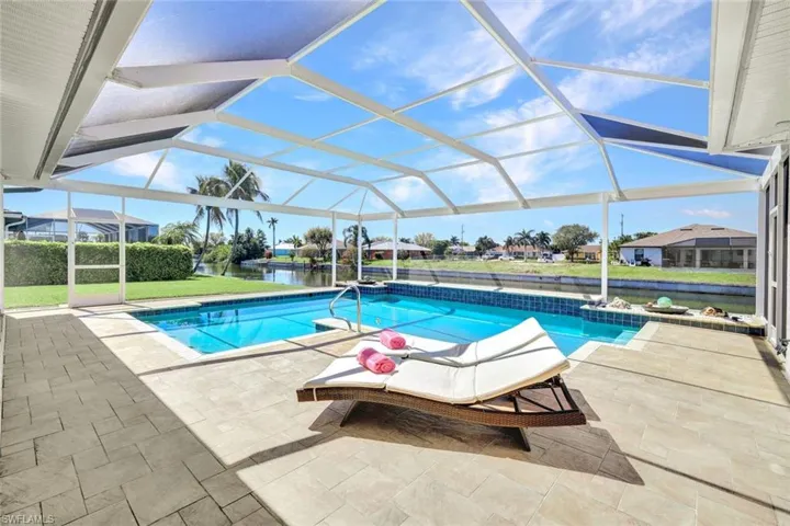Outdoor pool with a lanai and a patio