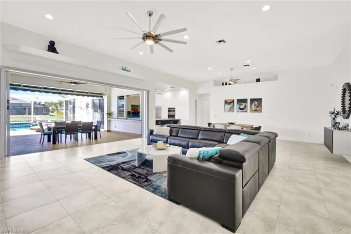 Living room featuring light tile patterned floors, baseboards, recessed lighting, and a ceiling fan