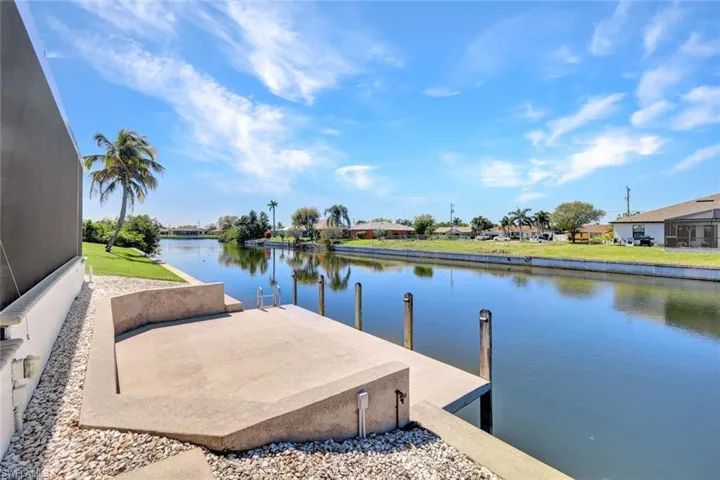 Dock area with a water view and a residential view