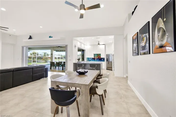 Dining area featuring light tile patterned flooring, recessed lighting, baseboards, and ceiling fan