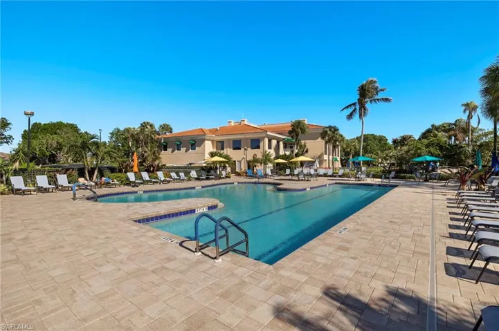 View of community swimming pool featuring a patio area