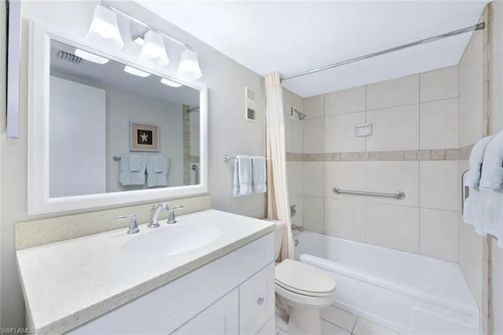 Full bathroom featuring tile patterned floors, vanity, toilet, and shower / bath combo