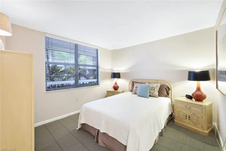Bedroom featuring dark colored carpet