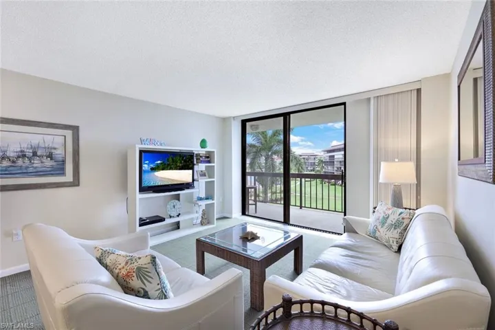 Living room with carpet and a textured ceiling