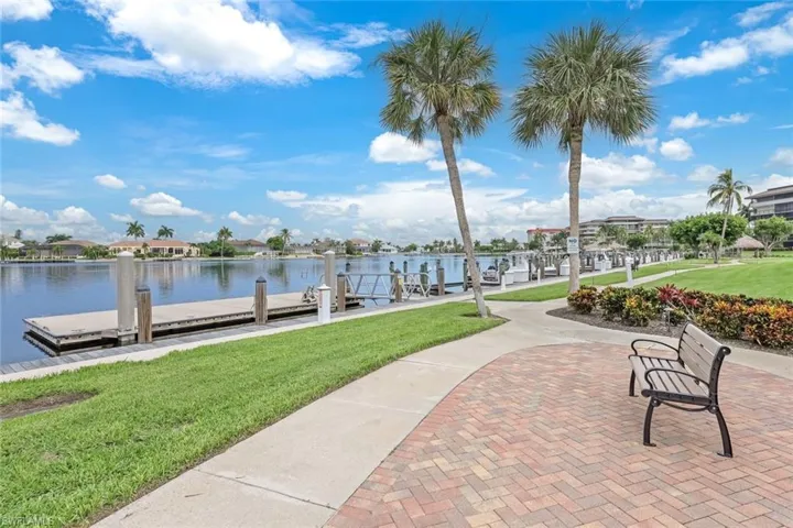View of dock featuring a water view and a lawn