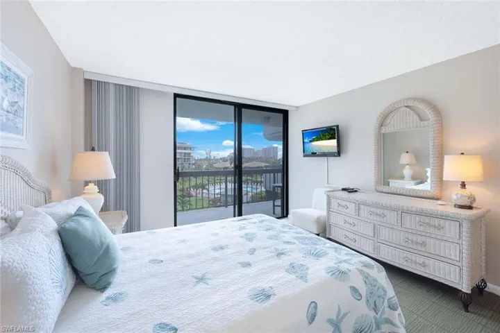Bedroom featuring a wall of windows and access to exterior
