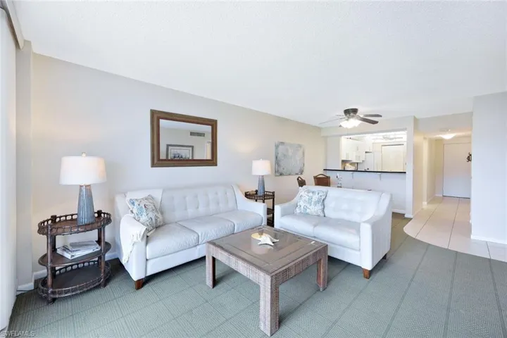 Living room with tile patterned floors and ceiling fan
