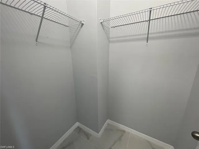 View of walk in closet in Primary Bedroom
