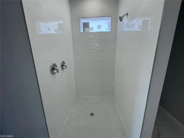 Primary Bathroom with a tile shower