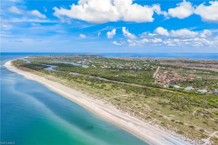 Drone / aerial view with a beach view and a water view