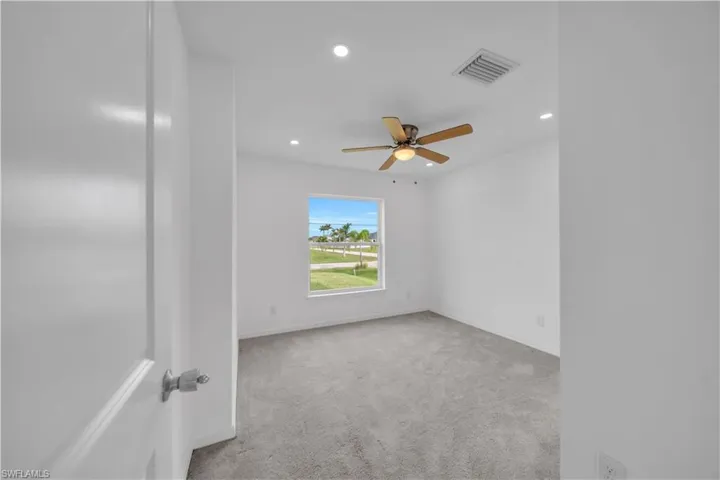 Unfurnished room with light colored carpet, recessed lighting, and ceiling fan