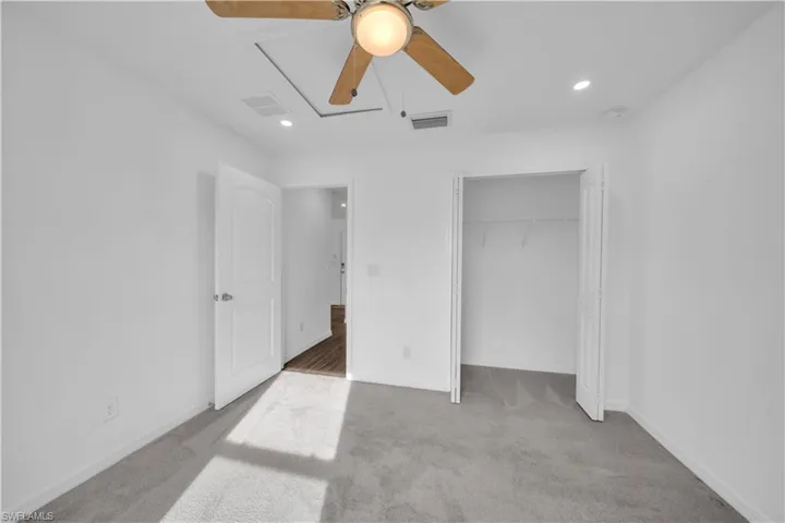 Unfurnished bedroom with light carpet, recessed lighting, a ceiling fan, and a closet