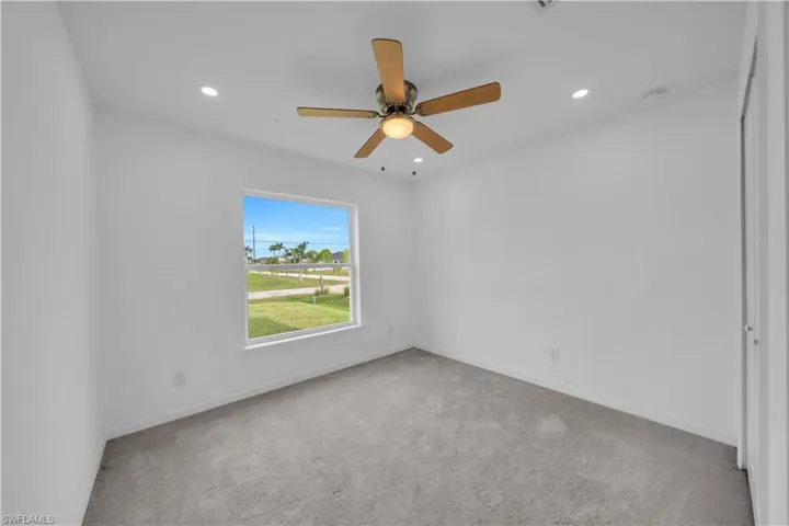 Unfurnished room with light carpet, recessed lighting, and a ceiling fan